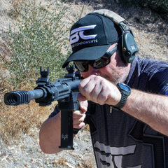 Clamp-on 12 gauge shotgun muzzle brake for unthreaded barrels — angled view