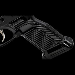 CZ Shadow 2 magwell-cut solid brass grips in black plated finish on a dark background