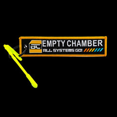 High-visibility centrefire chamber safety flag, empty chamber indicator — close-up detail